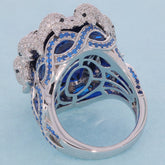 Elegantly designed sterling silver ring featuring blue sapphires and sparkling accents, perfect for luxurious style.